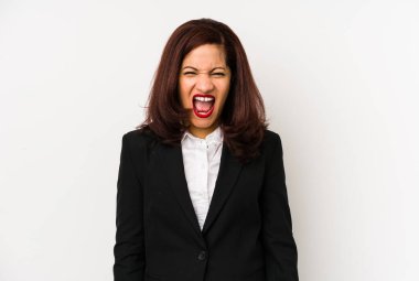 Middle age latin business woman isolated screaming very angry and aggressive.