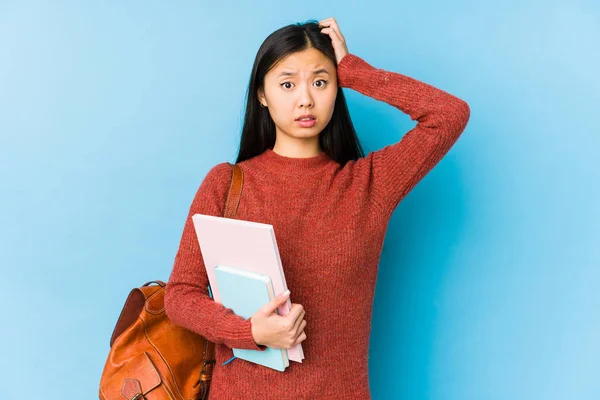 Young chinese student woman isolated being shocked, she has remembered important meeting.