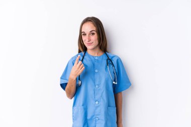 Young nurse woman isolated pointing with finger at you as if inviting come closer.