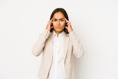 Young woman isolated on a white background focused on a task, keeping forefingers pointing head.