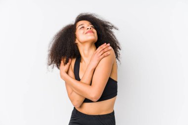 Young african american sporty woman hugs, smiling carefree and happy.