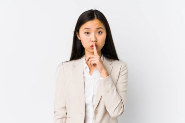 Young chinese business woman isolated keeping a secret or asking for silence.