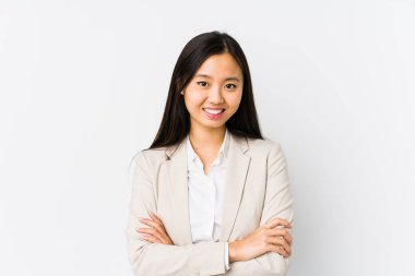 Young chinese business woman isolated who feels confident, crossing arms with determination.