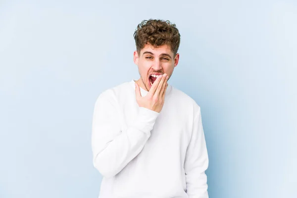 Young Blond Curly Hair Caucasian Man Isolated Yawning Showing Tired — Stock Photo, Image