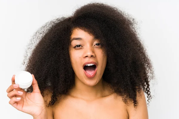 Young Afro Woman Holding Moisturizer Isolated Impressed Holding Copy Space — 图库照片
