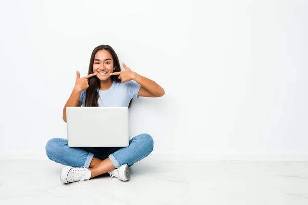 Young Mixed Race Indian Woman Sitting Working Laptop Smiles Pointing — ストック写真