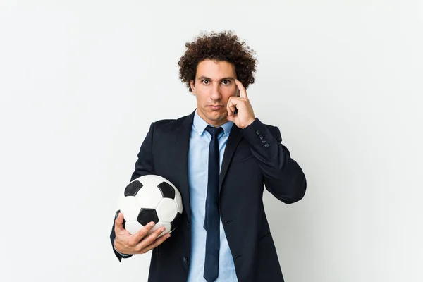 Soccer Trainer Holding Ball Pointing His Temple Finger Thinking Focused — 图库照片