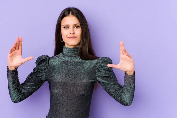 Young Caucasian Woman Isolated Purple Background Holding Something Little Forefingers — Stock Photo, Image
