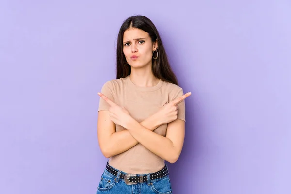 Young Caucasian Woman Isolated Purple Background Points Sideways Trying Choose — Stock Photo, Image