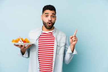 Yanları gösteren gözleme tutan genç latin adam.