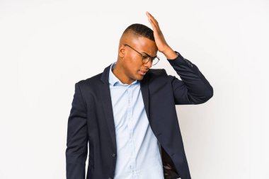 Young business latin man isolated on white background forgetting something, slapping forehead with palm and closing eyes.