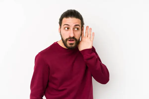 Giovane Uomo Capelli Lunghi Isolato Uno Sfondo Bianco Cercando Ascoltare — Foto Stock