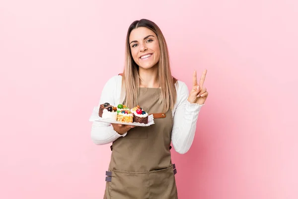 Jeune Boulanger Femme Tenant Des Bonbons Joyeux Insouciant Montrant Symbole — Photo