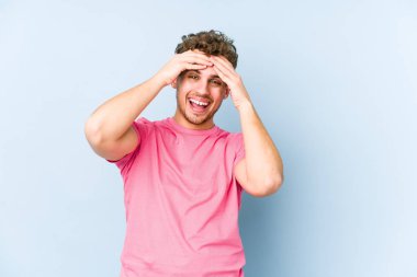 Sarışın, kıvırcık saçlı, beyaz tenli bir adam yalnız kahkahalar atıyor. Mutluluk kavramı.