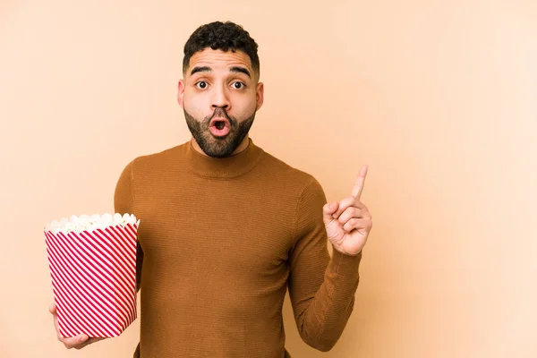 Young Latin Man Holding Pop Corn Isolated Pointing Side — Stock Photo, Image