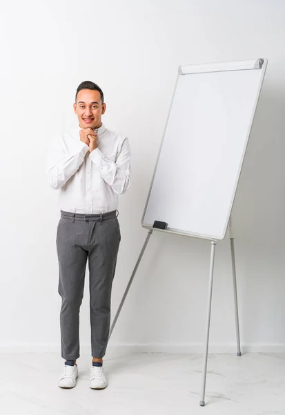 Young Latin Coaching Man Whiteboard Isolated Keeps Hands Chin Looking — Stock Photo, Image