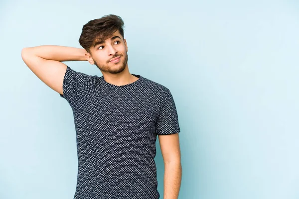 Jonge Arabische Man Geïsoleerd Een Blauwe Achtergrond Raken Achterkant Van — Stockfoto