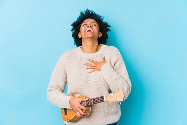 Young African American Woman Playing Ukelele Isolated Laughs Out Loudly — Stock Photo, Image