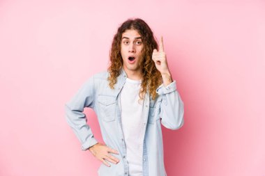 Uzun saçlı adam yalnız poz veriyor. Bir fikri, ilham verici bir fikri var..