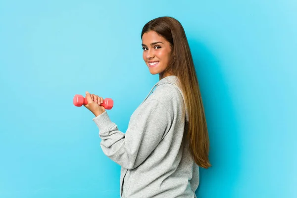 Young Caucasian Woman Holding Dumbbell Isolated Blue Background — Stok fotoğraf