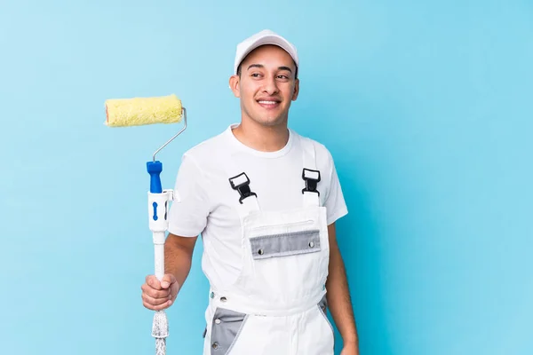 Young Professional Painter Latin Man Isolated Looks Aside Smiling Cheerful — Stockfoto