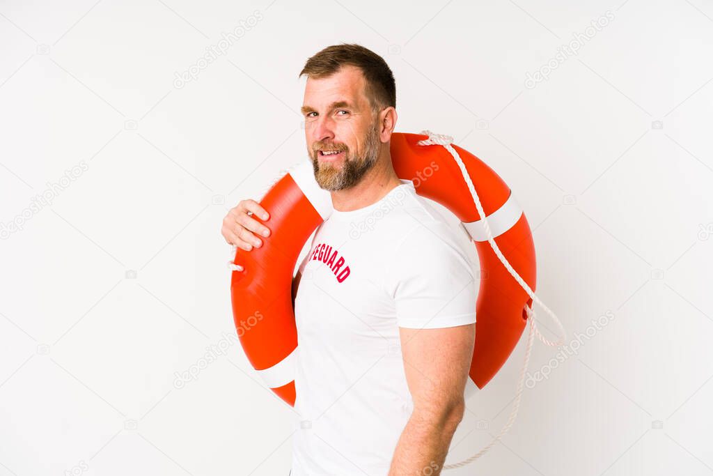 Senior lifeguard man isolated on white background looks aside smiling, cheerful and pleasant.