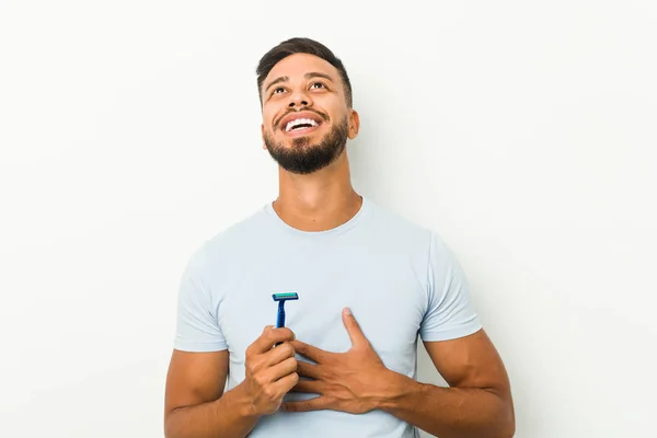 Young South Asian Man Holding Razor Blade Laughs Out Loudly — Stock Photo, Image