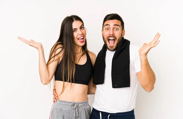 Young Caucasian Fitness Couple Isolated Receiving Pleasant Surprise Excited Raising — 스톡 사진