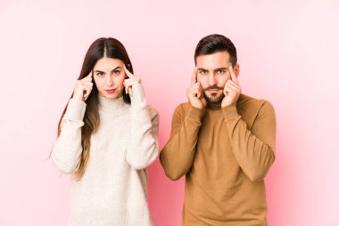 Kafkasyalı genç çift bir göreve odaklanmış, işaret parmaklarını işaret ediyor..