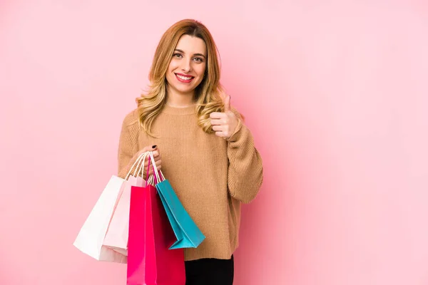 Ung Blond Kvinna Håller Shoppingpåsar Isolerade Leende Och Höja Tummen — Stockfoto