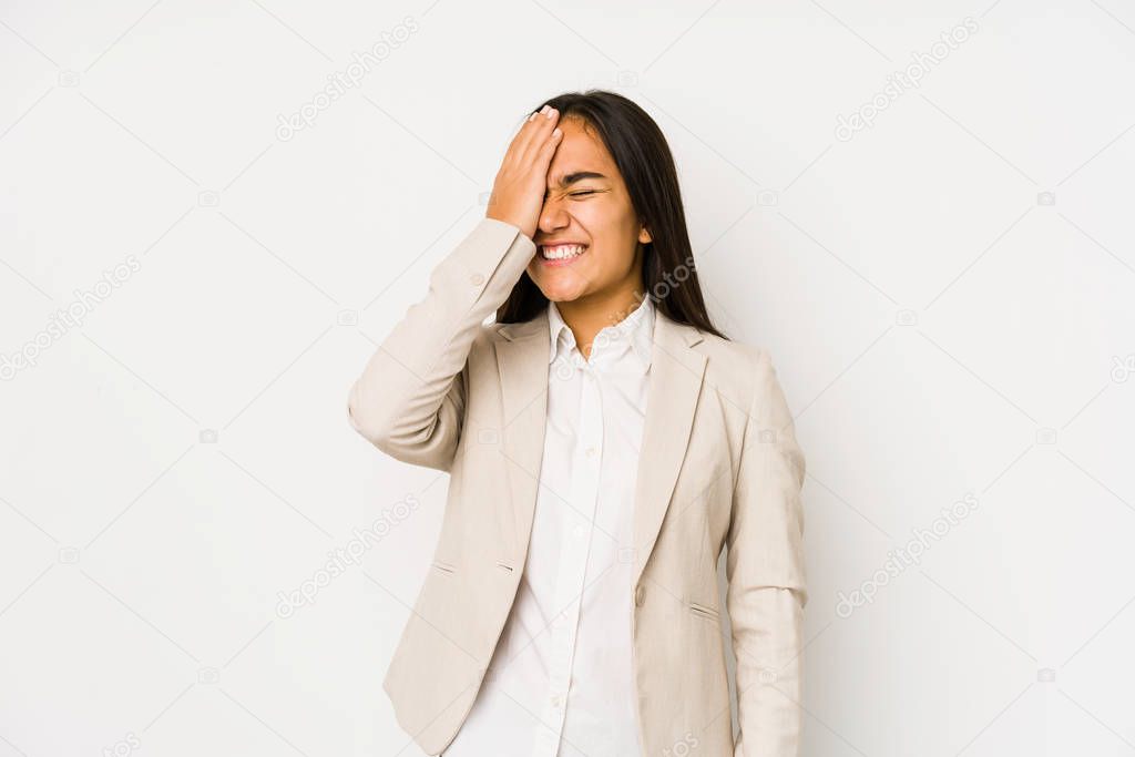 Young woman isolated on a white background forgetting something, slapping forehead with palm and closing eyes.