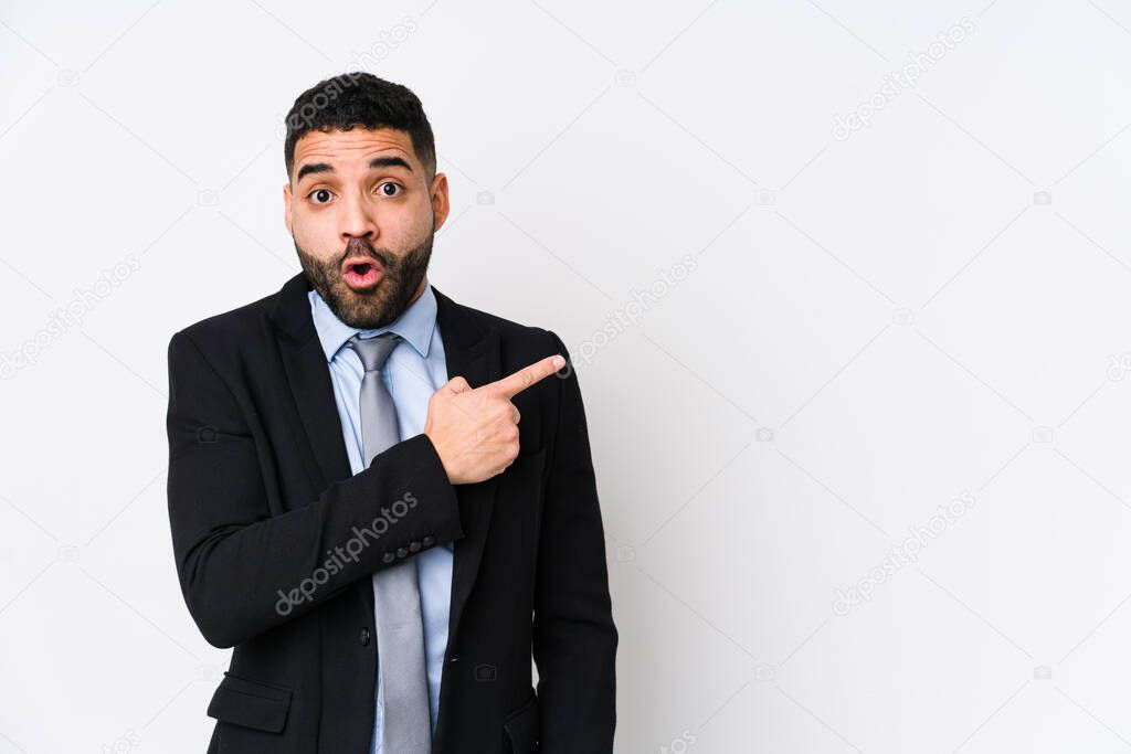 Young latin business woman against a white background isolated pointing to the side
