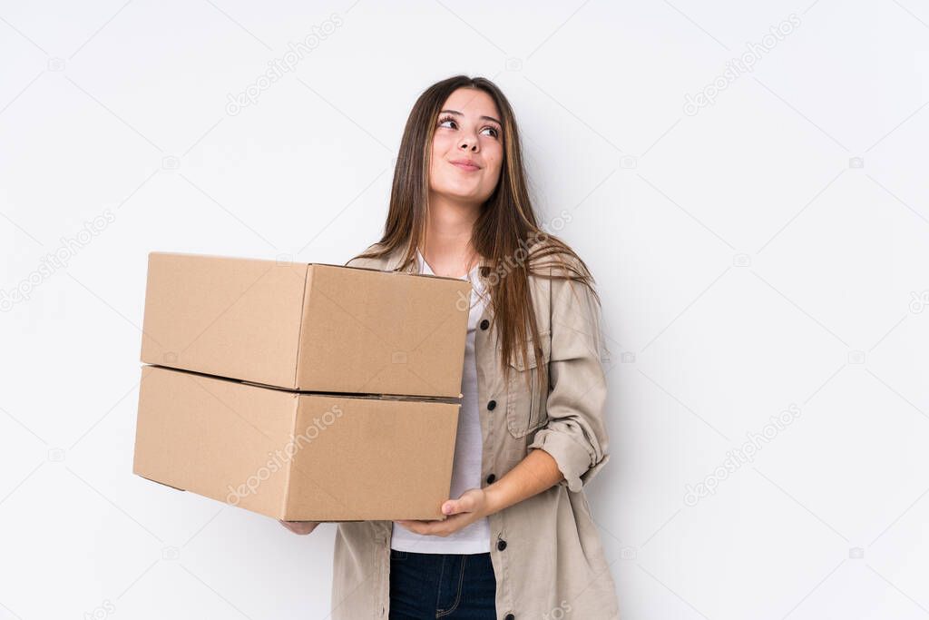 Young caucasian woman moving to a new home dreaming of achieving goals and purposes