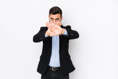 Young caucasian business man against a white background isolated doing a denial gesture