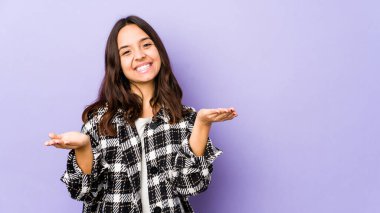 Genç, melez İspanyol bir kadın soyutlanmış, kollarıyla ölçek yapıyor, mutlu ve kendinden emin hissediyor..