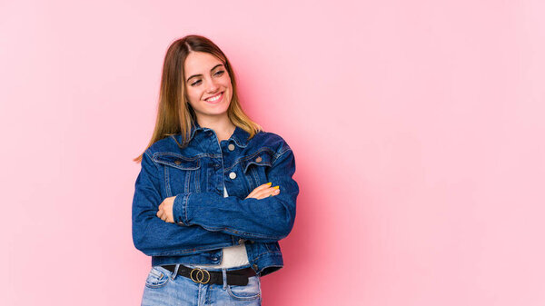 Young caucasian woman isolated on pink background smiling confident with crossed arms.