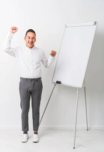 Young Latin Coaching Man Whiteboard Isolated Celebrating Special Day Jumps — Stock Photo, Image
