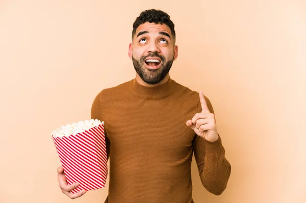 Young Latin Man Holding Pop Corn Isolated Pointing Upside Opened — Stock Photo, Image