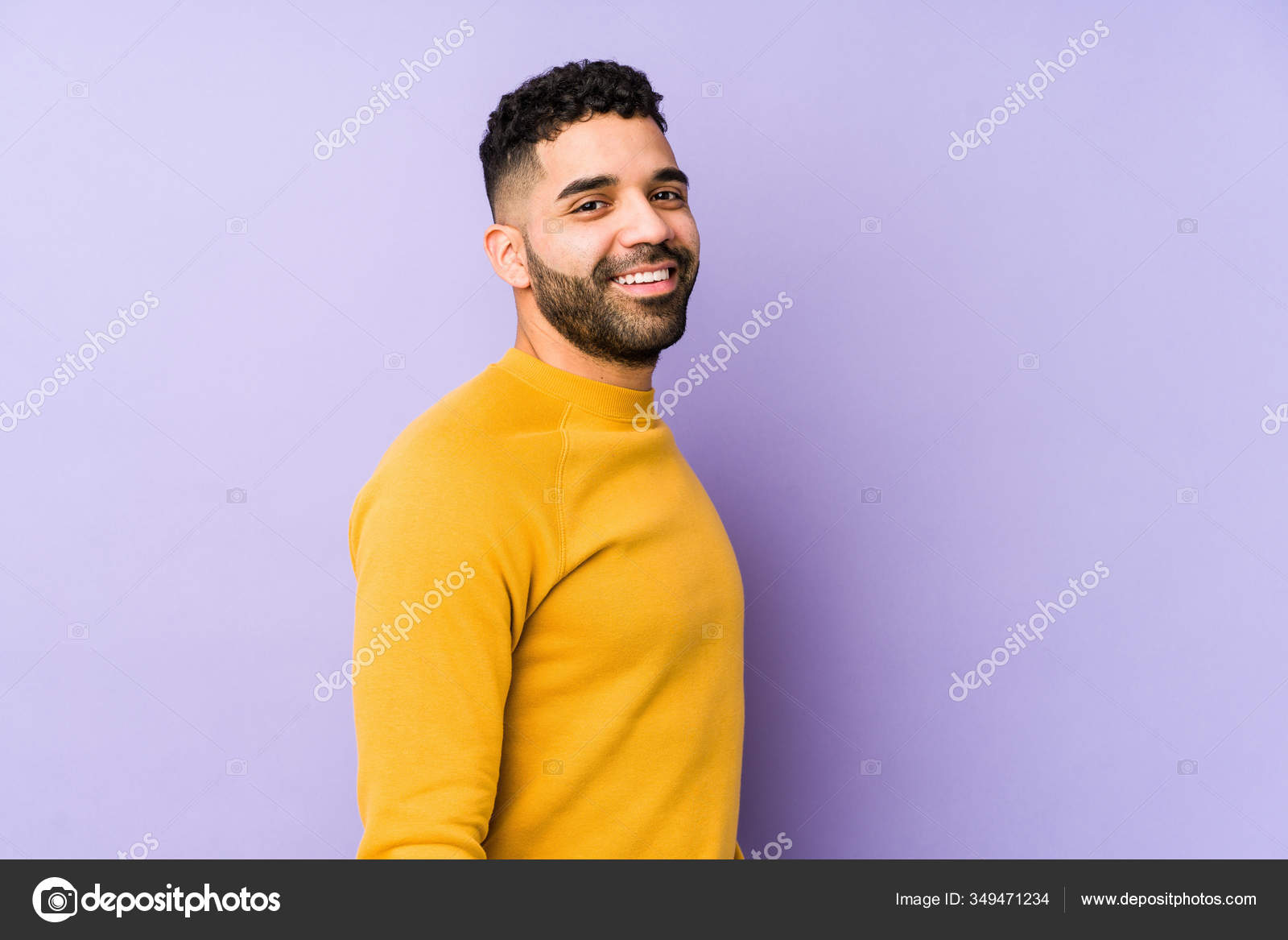 Young Mixed Race Arabic Man Isolated Looks Aside Smiling Cheerful Stock Photo by