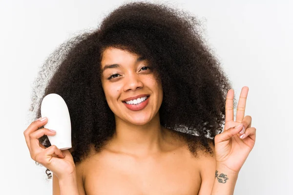 Young Afro Woman Holding Moisturizer Isolated Showing Number Two Fingers — Stock Photo, Image