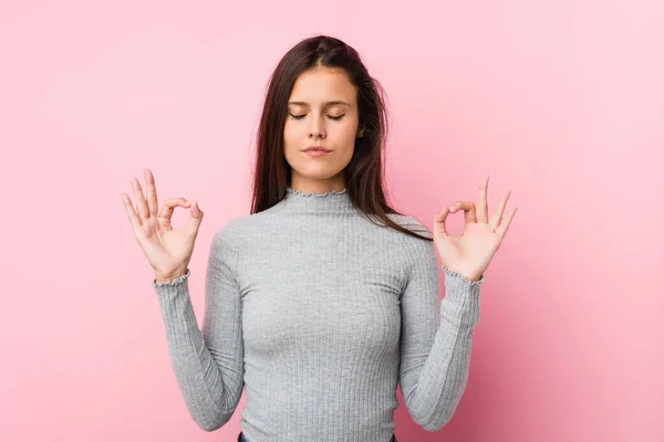 stock image Young cute woman relaxes after hard working day, she is performing yoga.