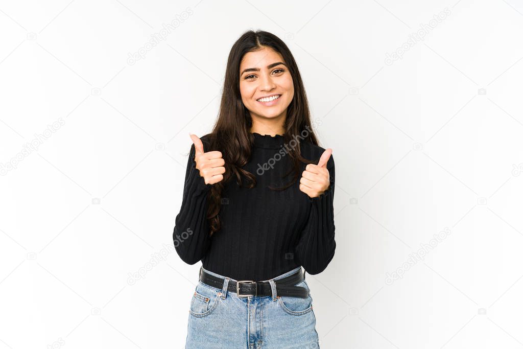 Young indian woman isolated on purple background smiling and raising thumb up