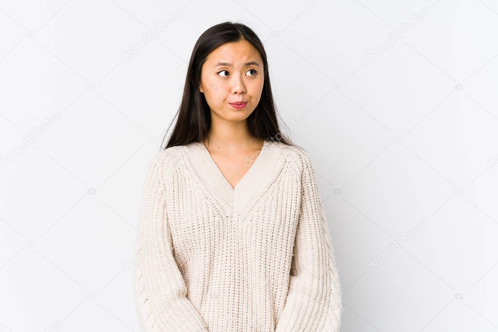 Young chinese woman isolated confused, feels doubtful and unsure.