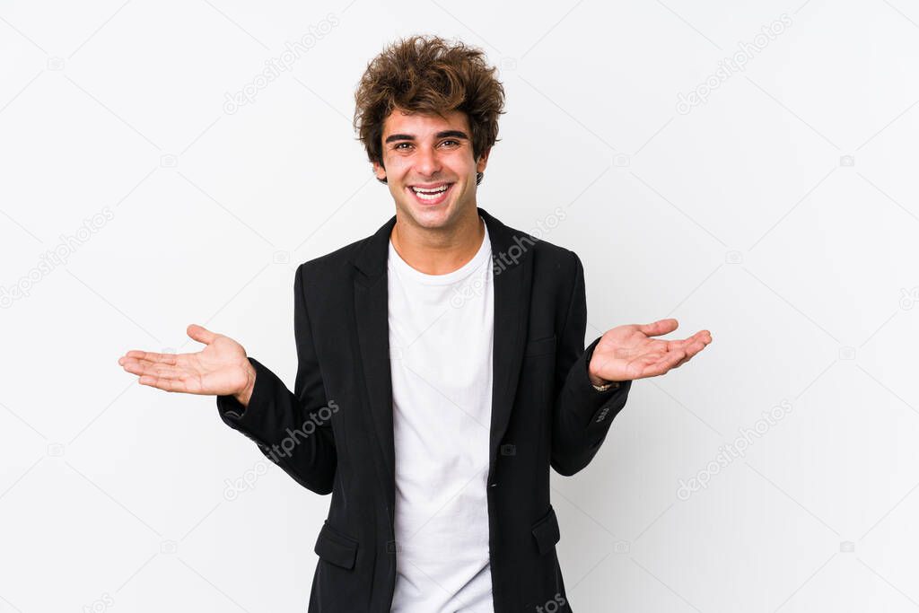 Young caucasian business man against a white background isolated showing a welcome expression.
