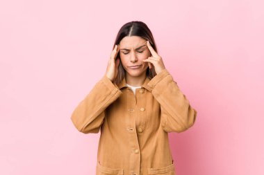 Genç beyaz kadın tapınaklara dokunuyor ve baş ağrısı çekiyor..