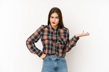 Beyaz arka planda soyutlanmış beyaz bir kadın sorgulama sırasında omuz silkiyor ve şüphe duyuyor..