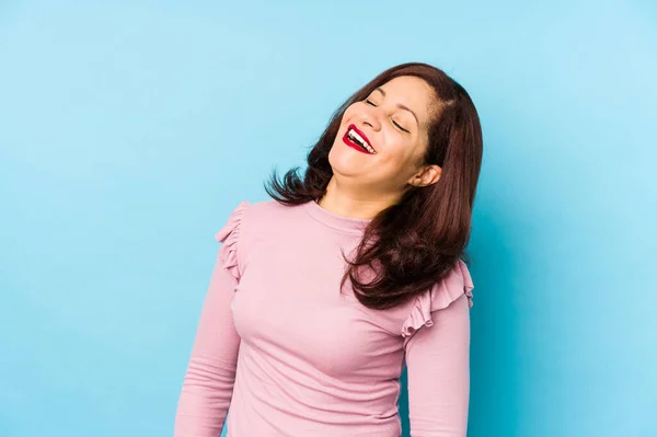 Middle age latin woman isolated relaxed and happy laughing, neck stretched showing teeth.