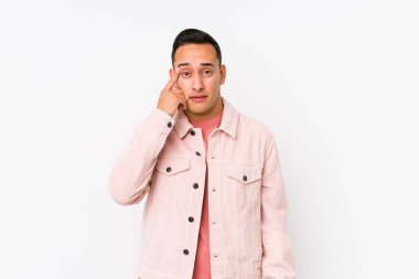 Genç latin adam yalnız poz veriyor işaret parmağıyla hayal kırıklığı işareti yapıyor..