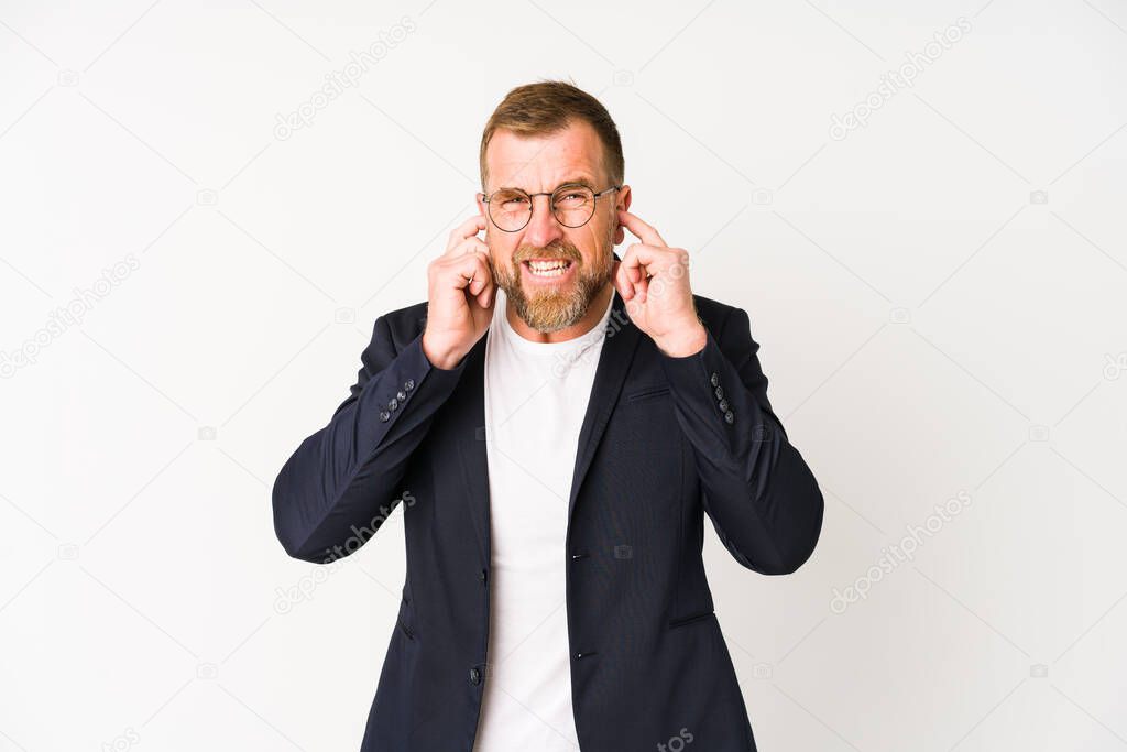 Senior business man isolated on white background covering ears with hands.