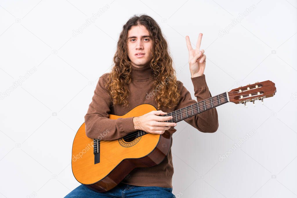 Young caucasian man playing guitar isolated showing number two with fingers.